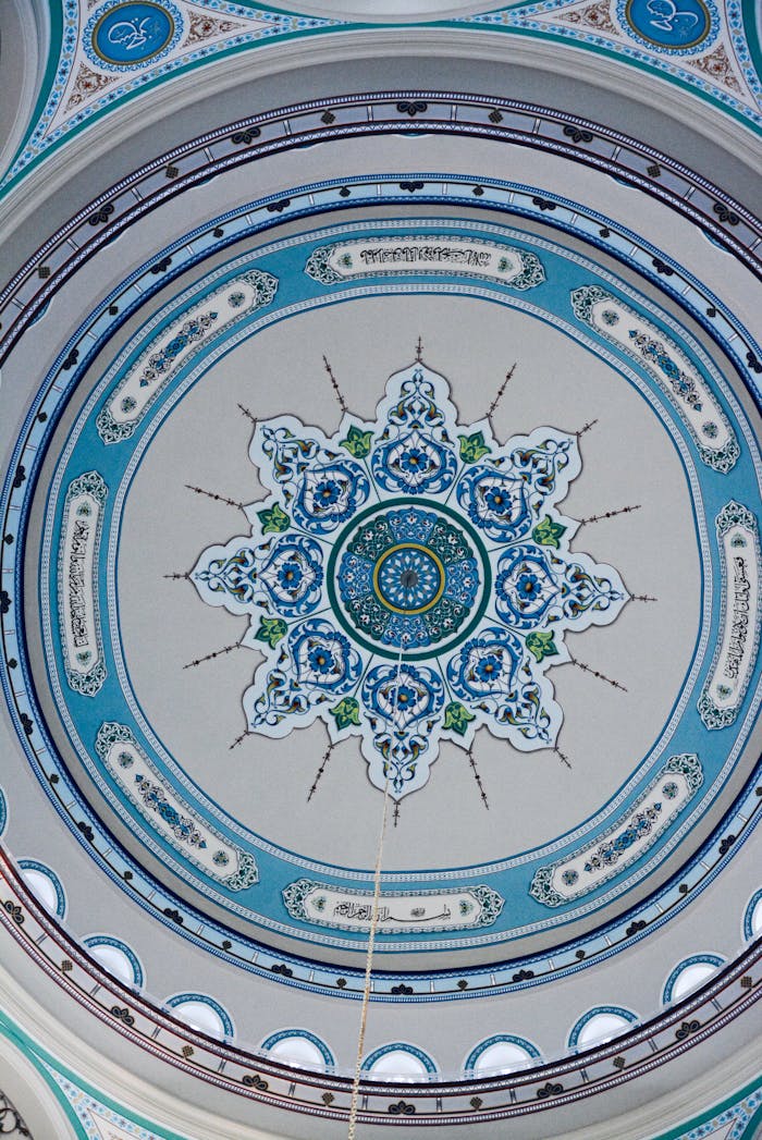 Detailed view of an ornate Islamic geometric ceiling design in blue and white.